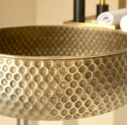 Oxidized copper vessel sink with a textured hammered design showcasing its unique craftsmanship.