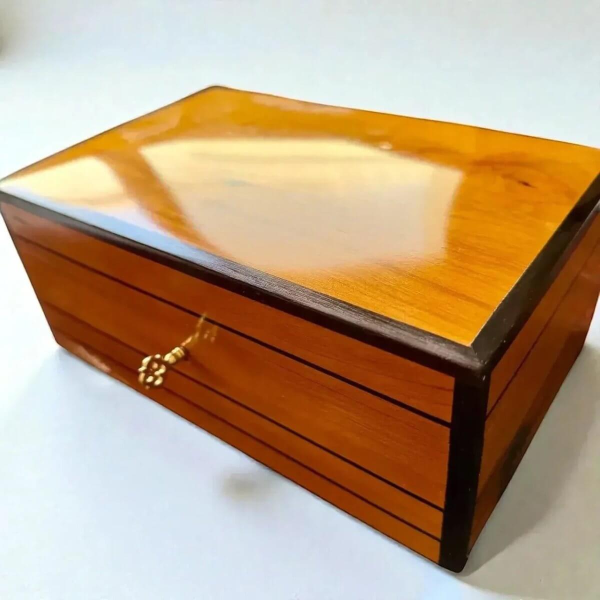 Decorative Wooden Keepsake Box made of Thuya burl wood, featuring a shiny surface and decorative brass clasp.