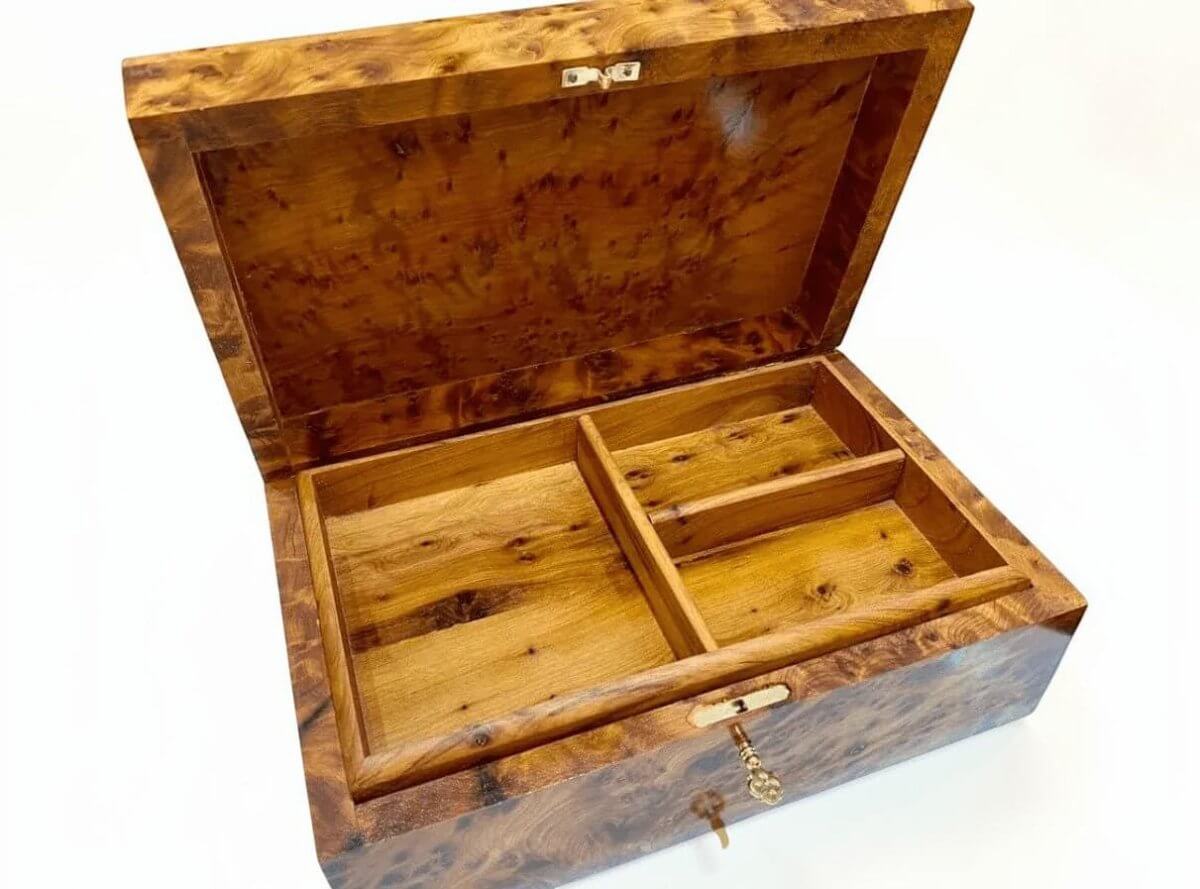 Divided interior of large wooden jewelry box for rings and watches