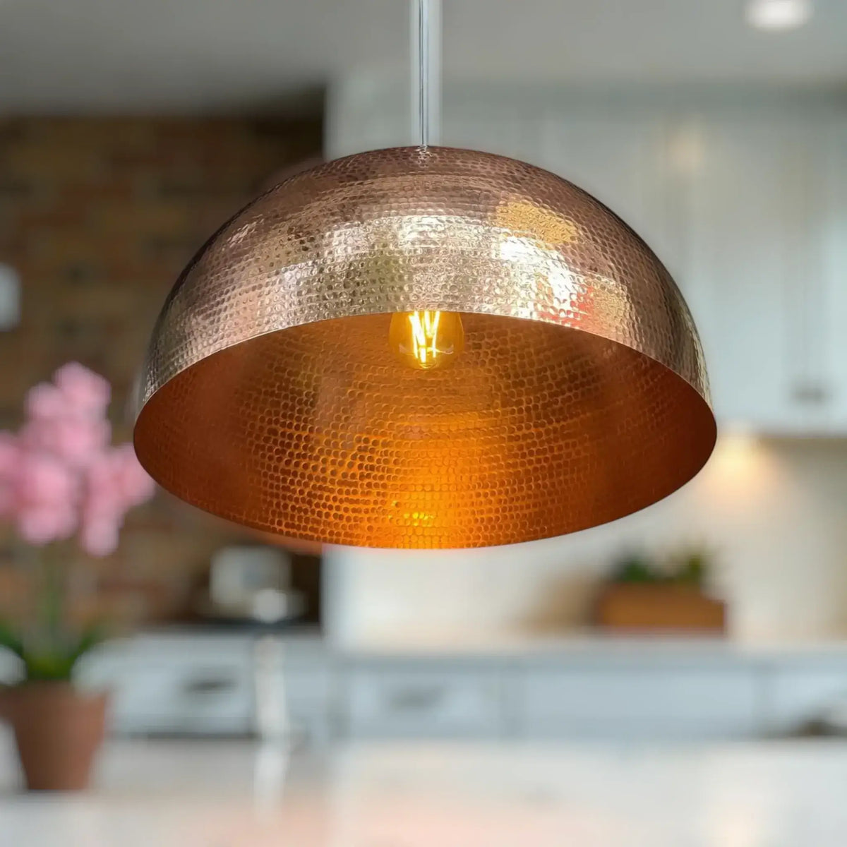 Handmade Copper Pendant Light with a hammered finish, illuminating a stylish kitchen space.
