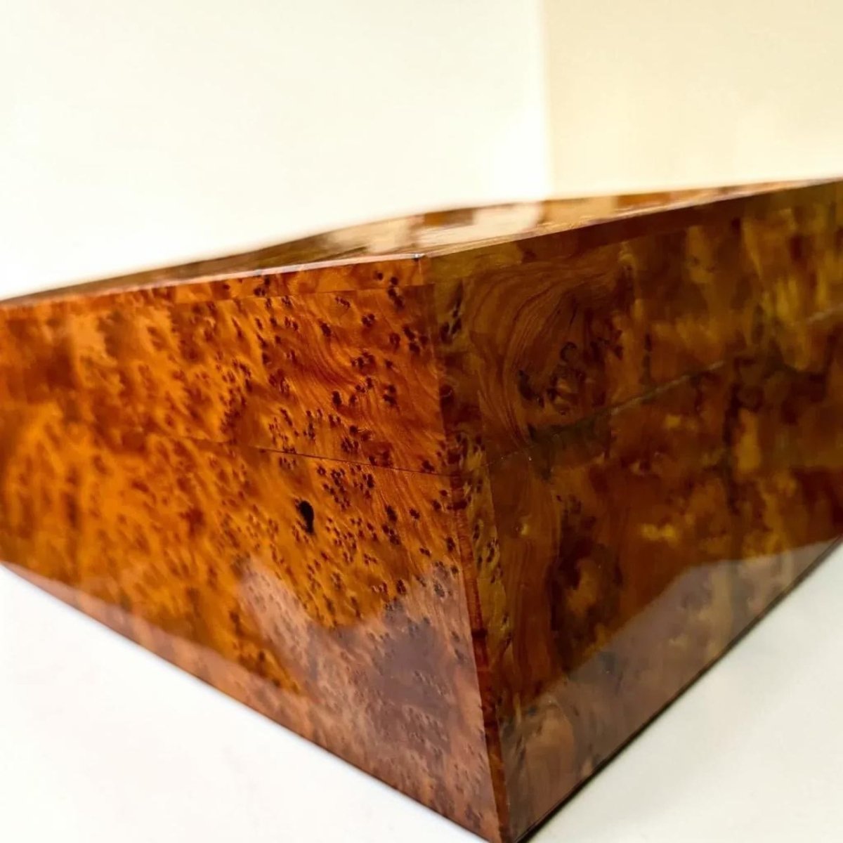 Thuya wood organizer box with brass detail and natural swirling grain