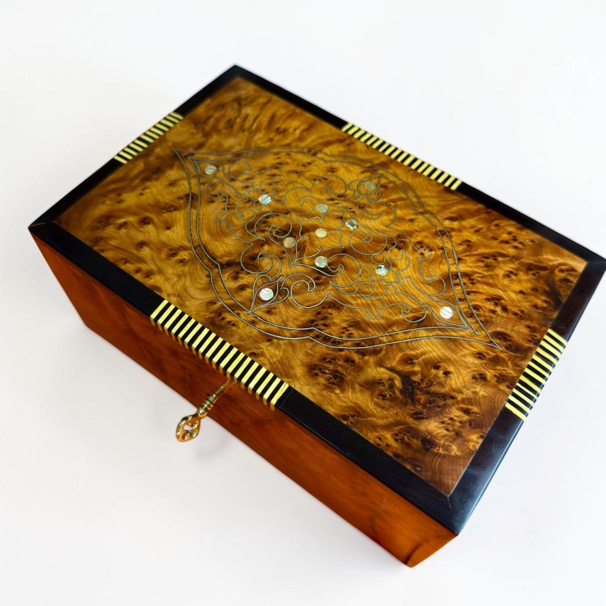 Lockable jewelry box made from Moroccan Thuya burl wood with brass key detail