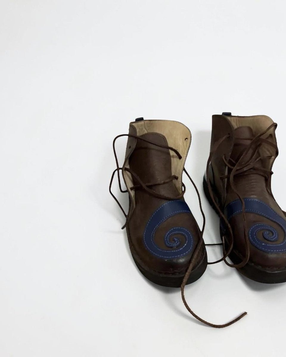 AtlasMuseCrafts brown leather medieval poulaines with blue swirl detail and pointed toe, lace-up closure.