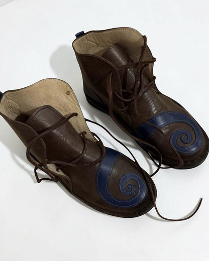 AtlasMuseCrafts brown leather poulaines with blue spiral detail and pointed toe, lace-up closure.