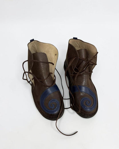 AtlasMuseCrafts brown leather medieval pointed toe shoes with blue spiral detail and side laces. Handmade for LARP, cosplay, and reenactment.