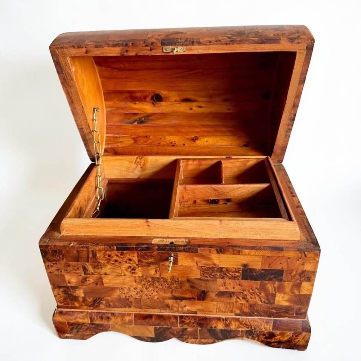 AtlasMuseCrafts handmade Thuya burl wooden box with coffer-style lid, brass lock, and interior compartments. Features unique burl grain patterns and warm wood tones.