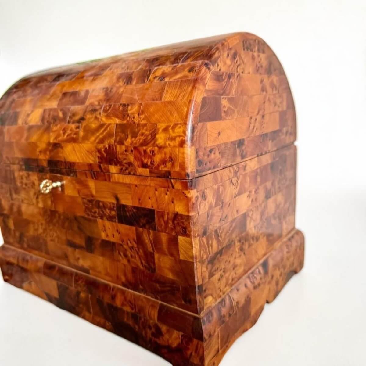AtlasMuseCrafts handmade Thuya burl wood coffer-style chest with brass key lock and intricate wood grain patterns.