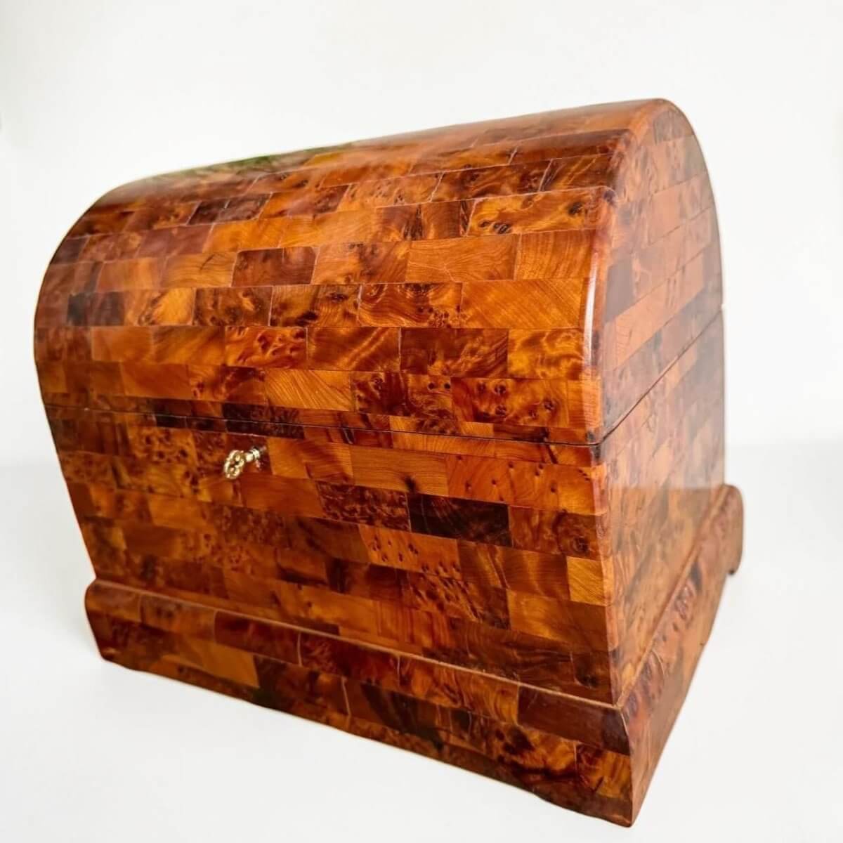 AtlasMuseCrafts handmade Thuya burl wooden box with coffer-style design and brass lock. Rich, swirling wood grain.