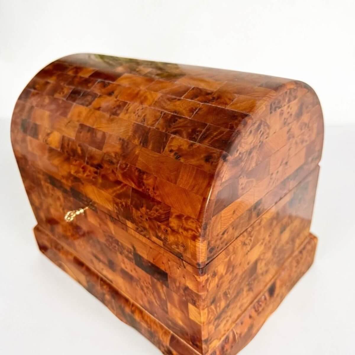 AtlasMuseCrafts handmade Thuya burl wood coffer-style chest with brass lock and intricate wood grain patterns.