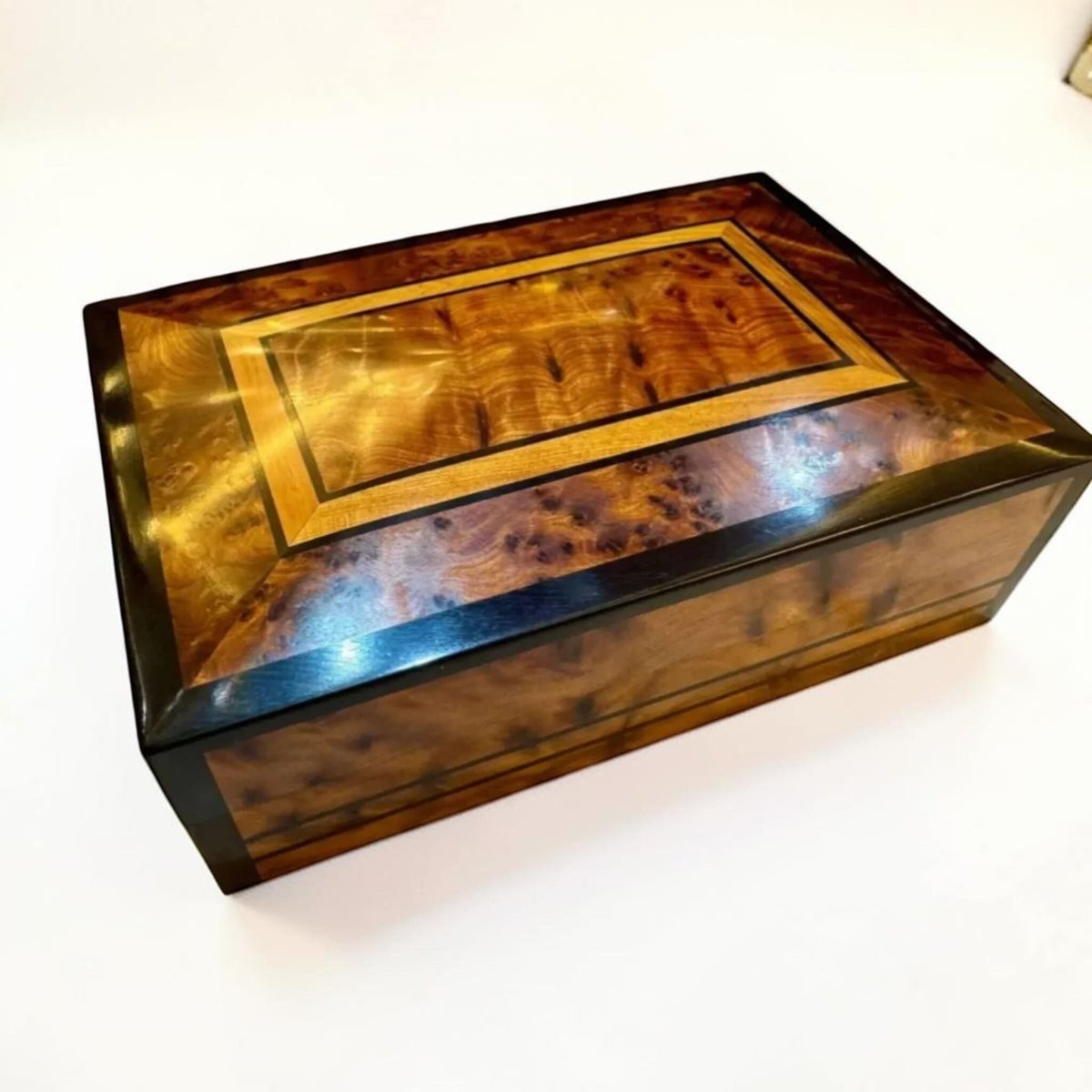 Thuya burl wood storage box with dark inlay and polished grain