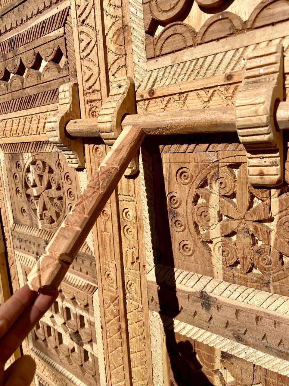 Berber carved wooden door — close detail of tribal motifs