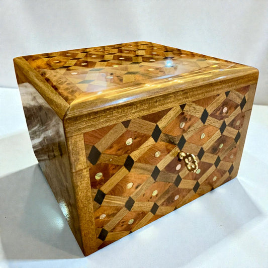Wooden jewelry box with intricate design on a white background