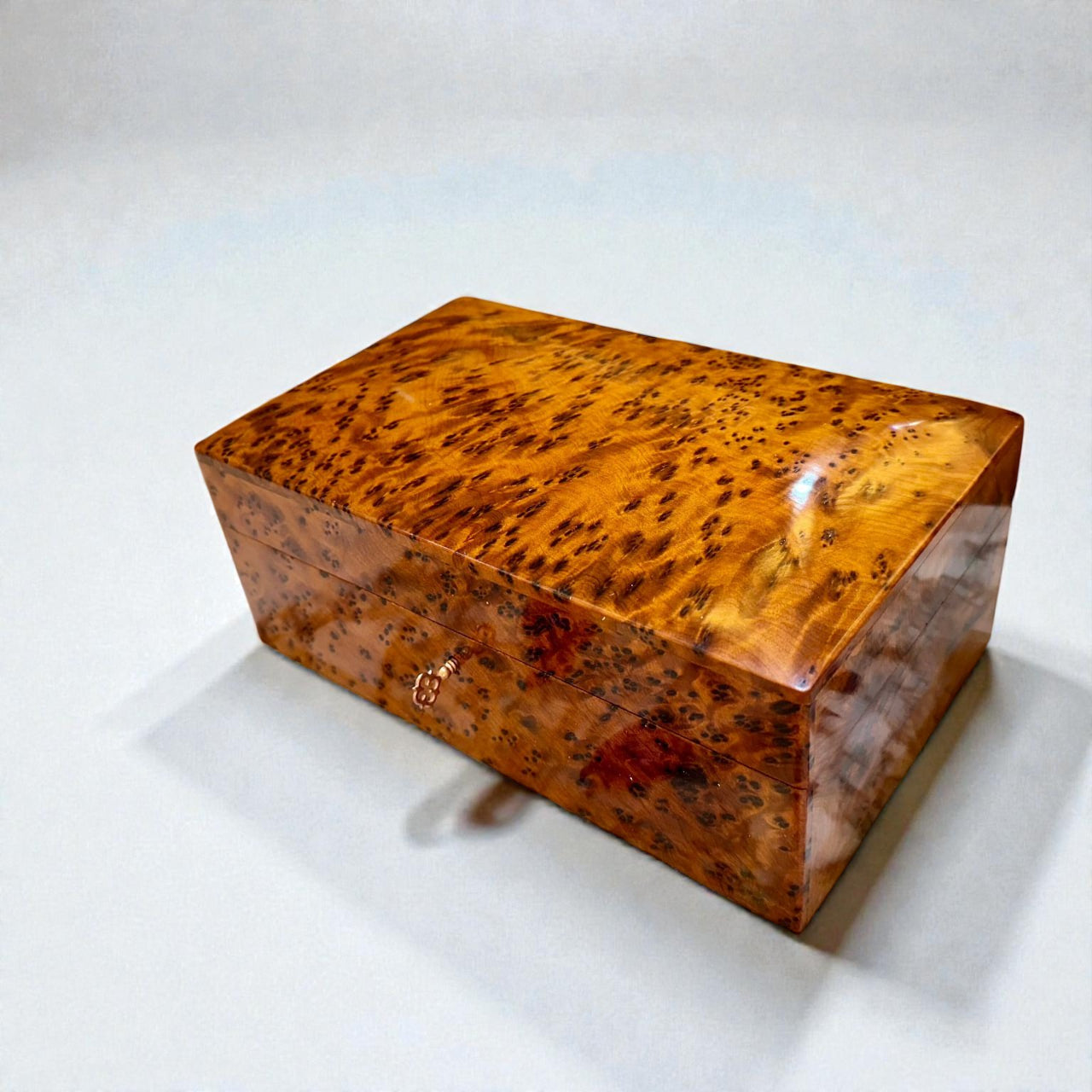 Wooden Box With Key made of Thuya burl, showcasing beautiful grain and rich color.