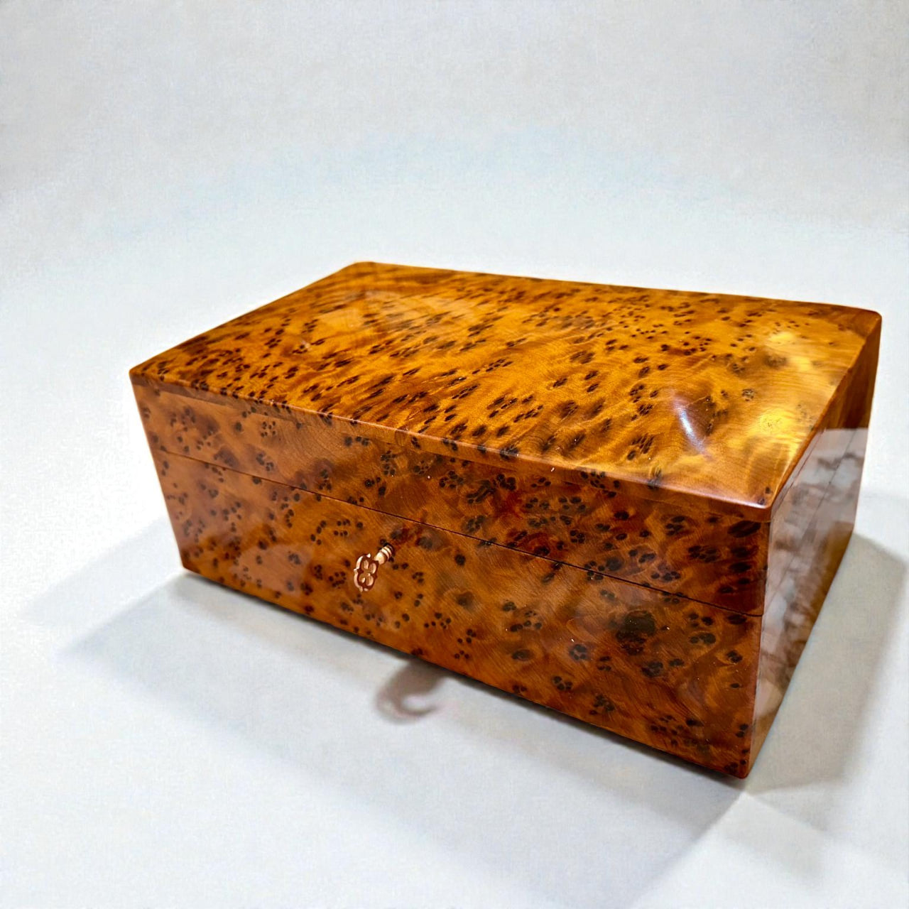 Wooden jewelry box with a distinctive grain pattern on a white background