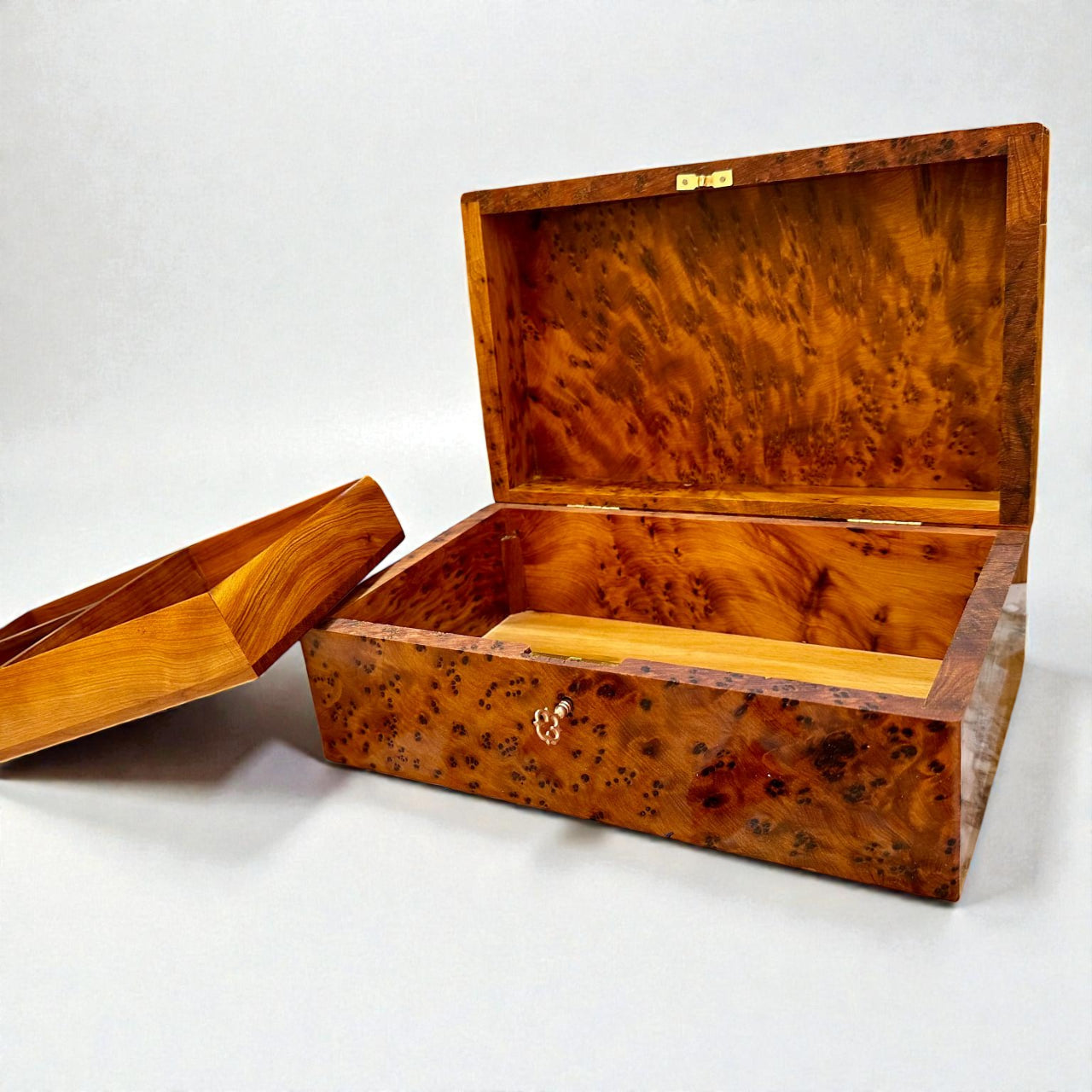 Wooden Box With Key made from Thuya burl showing its intricate grain and open design.