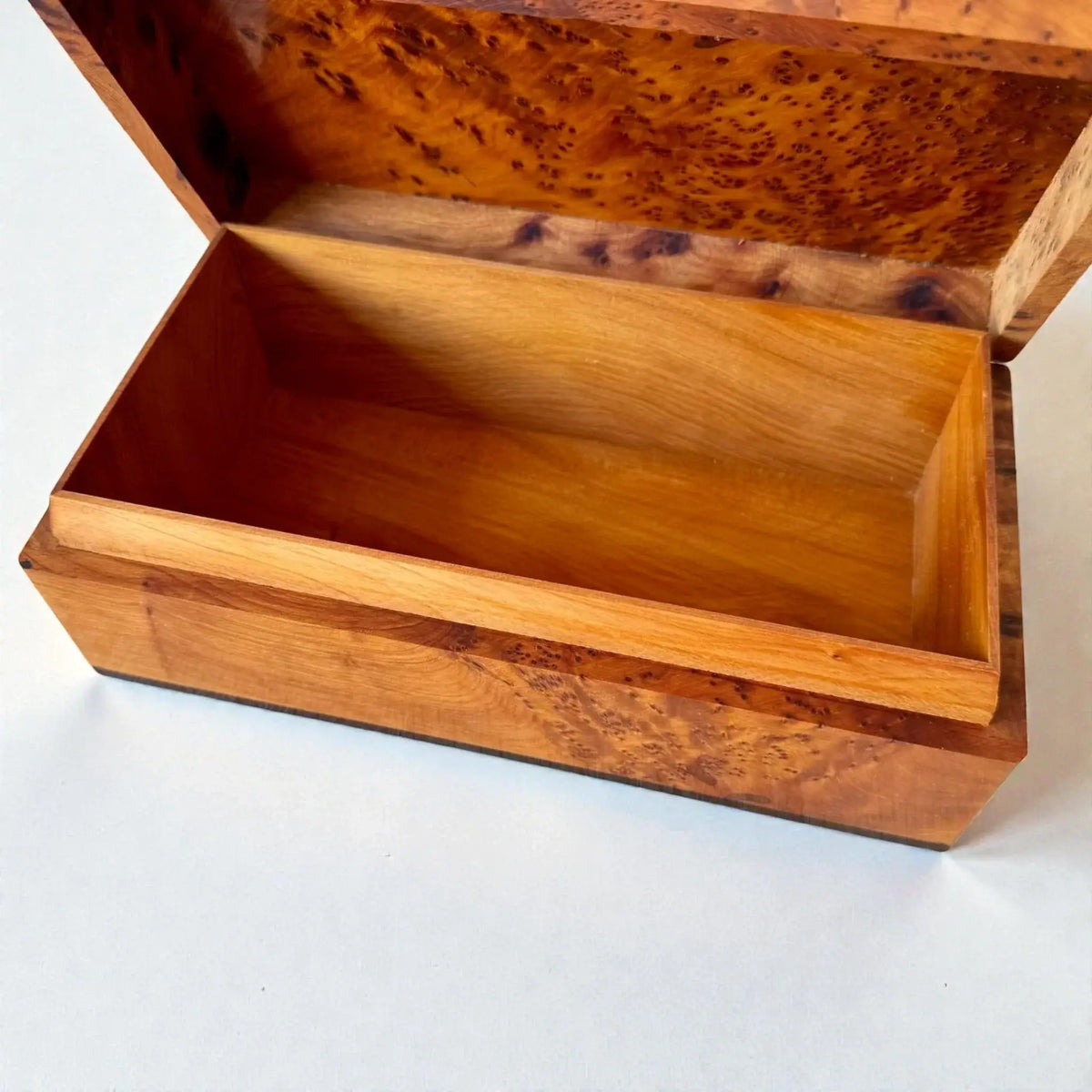 Moroccan Wooden Chest – Handmade Thuya Wood Keepsake Box showcasing natural grain and warm amber interior as a jewelry box.