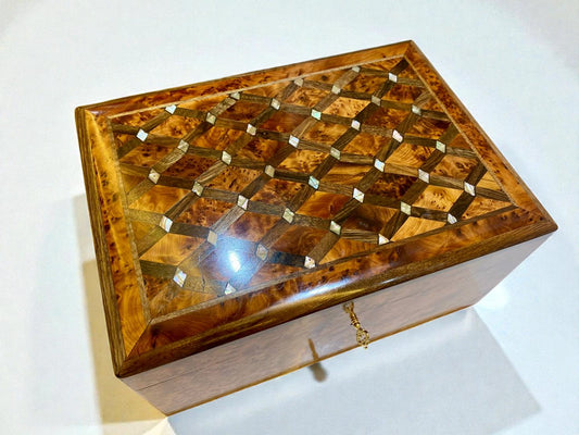 Wooden jewelry box with intricate inlay design on a white background