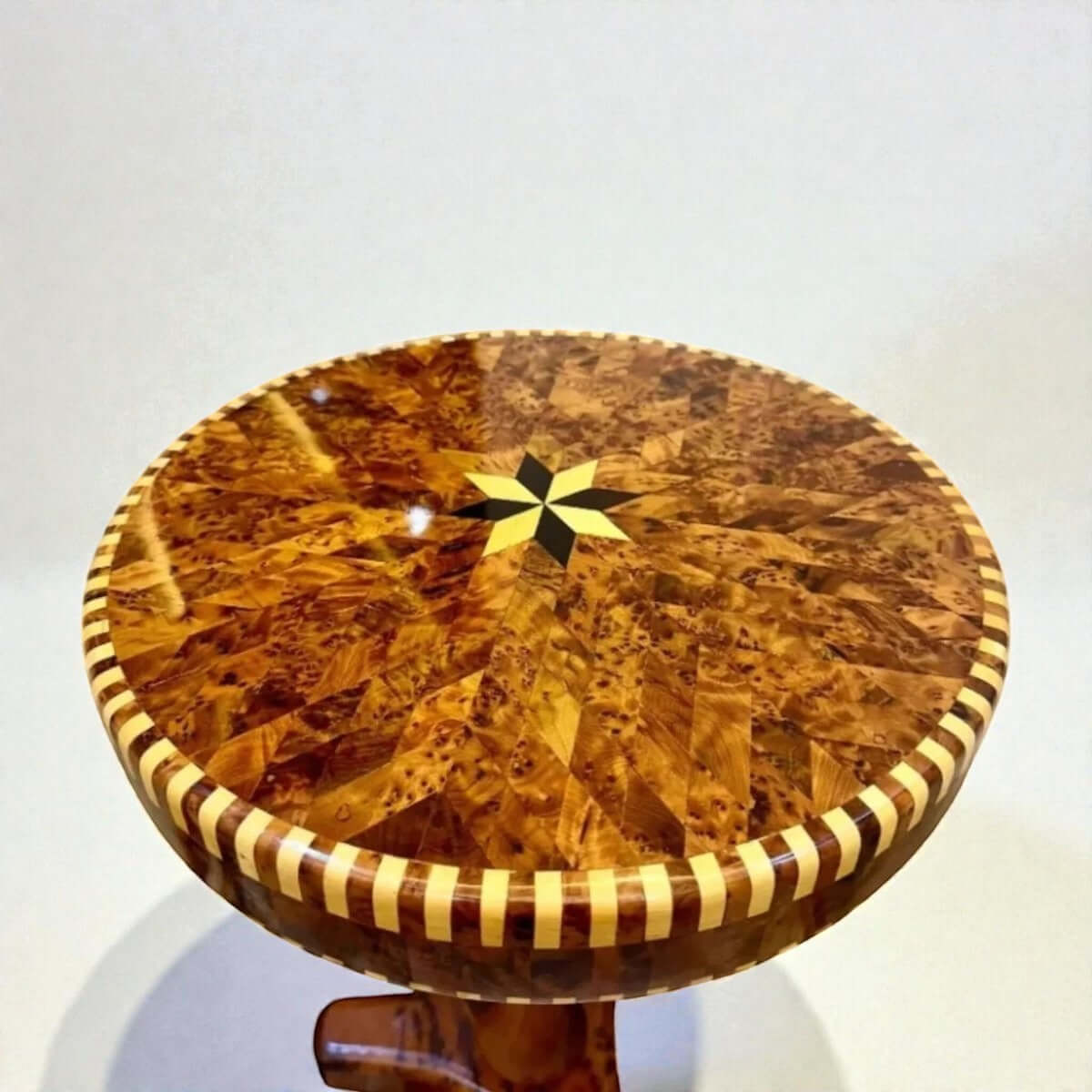 Round Moroccan Thuya coffee table with star inlay and striped border