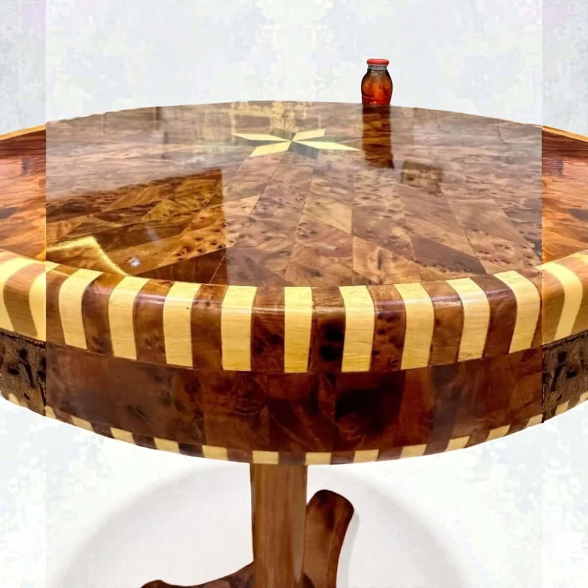 Round wood coffee table with Moroccan Thuya grain and starburst inlay