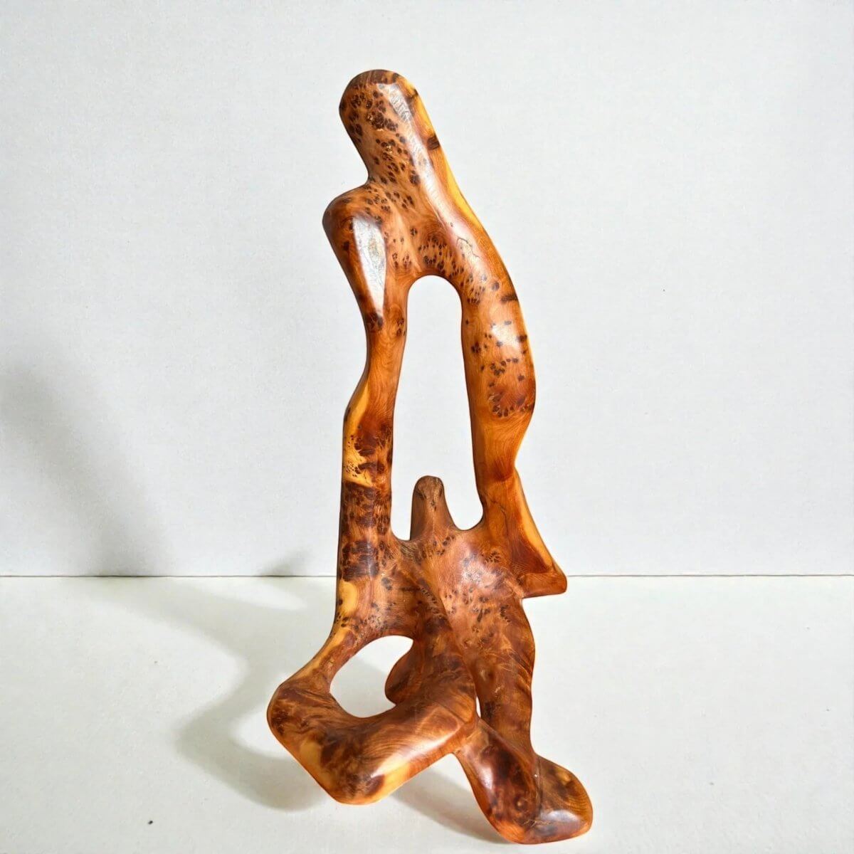 Carved Thuya wood sculpture with intricate natural grain