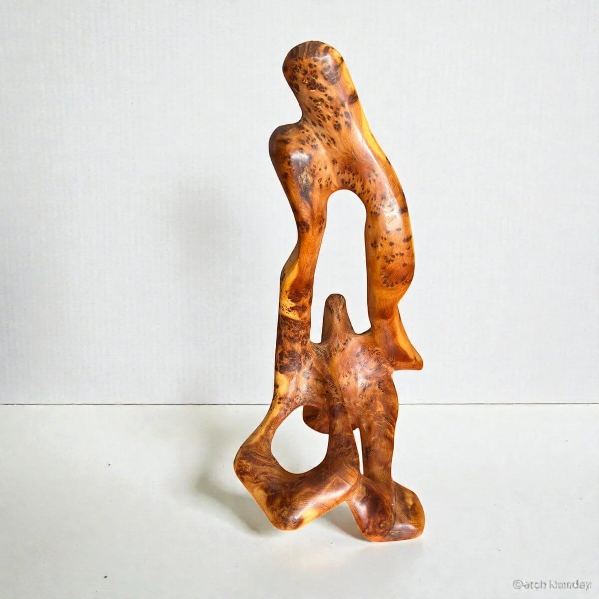 Natural Thuya wood sculpture with golden-brown grain and abstract form