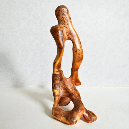 AtlasMuseCrafts abstract sculpture carved from natural Thuya wood, showcasing unique grain patterns and a warm golden-brown hue.