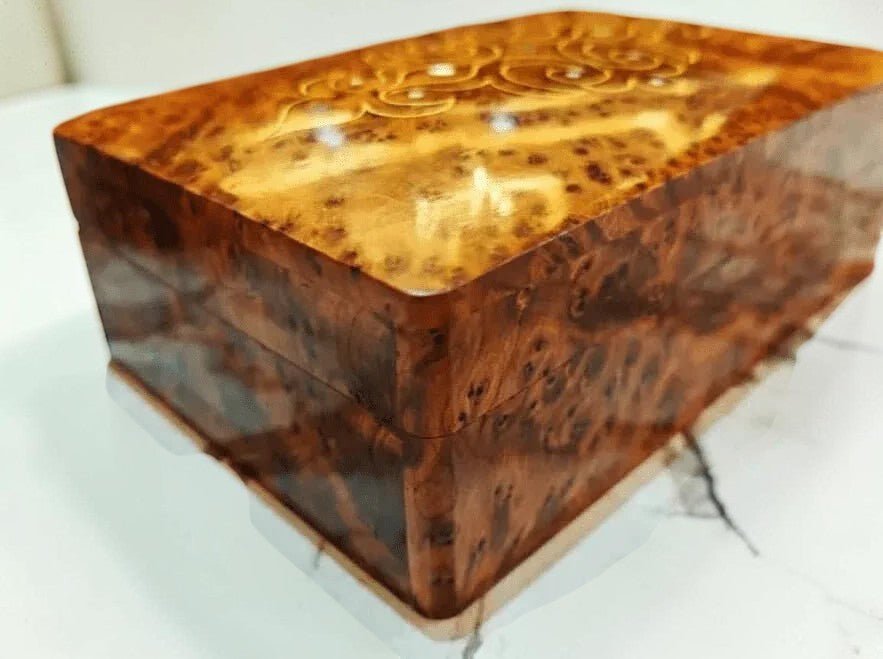 Decorative small burl wood keepsake box with ornate lid detail
