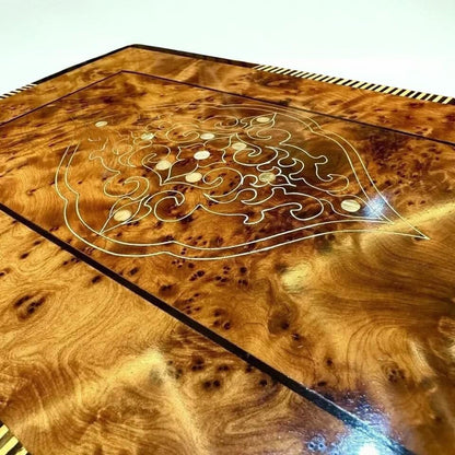 Close-up of Thuya burl wood box with decorative inlay pattern and natural swirling grain