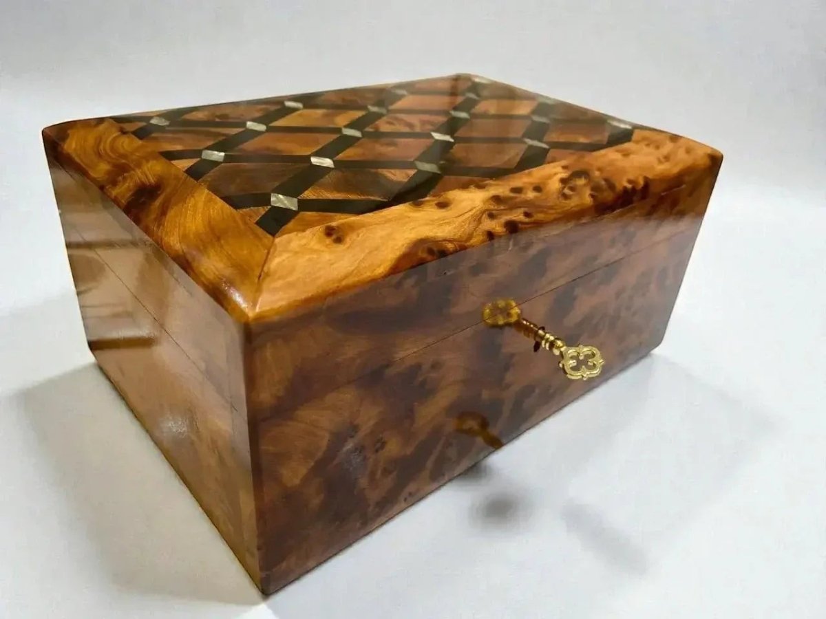 AtlasMuseCrafts handmade Thuya wood jewelry box with intricate marquetry lid and ornate gold latch. Features swirling grain patterns and a polished finish.