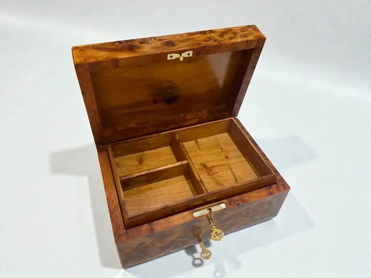 AtlasMuseCrafts handmade Moroccan Thuya wood jewelry box with unique swirling grain and brass latch. Interior has compartments for rings, bracelets, and keepsakes.