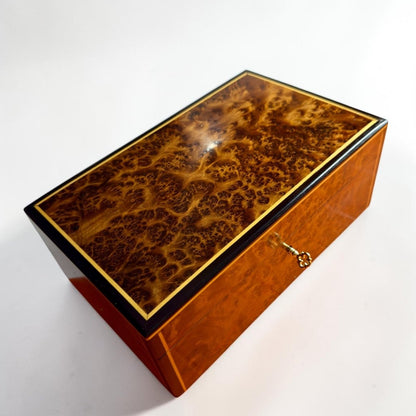 Wooden jewelry box with gold trim, brass lock, and Thuya burl grain