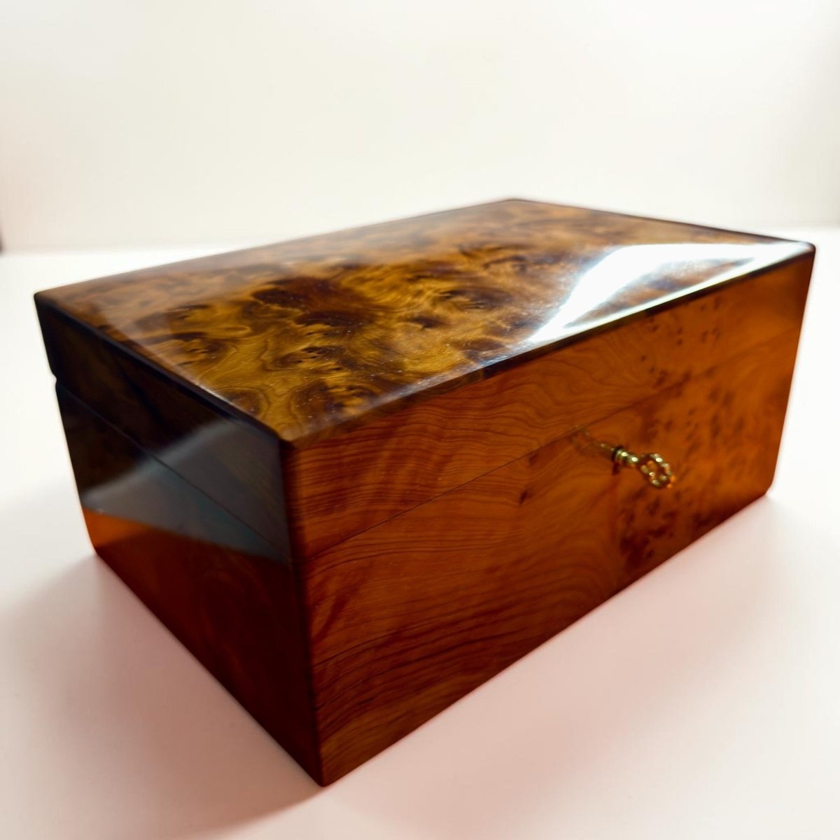 Handmade wooden organizer with key detail and warm Thuya burl grain