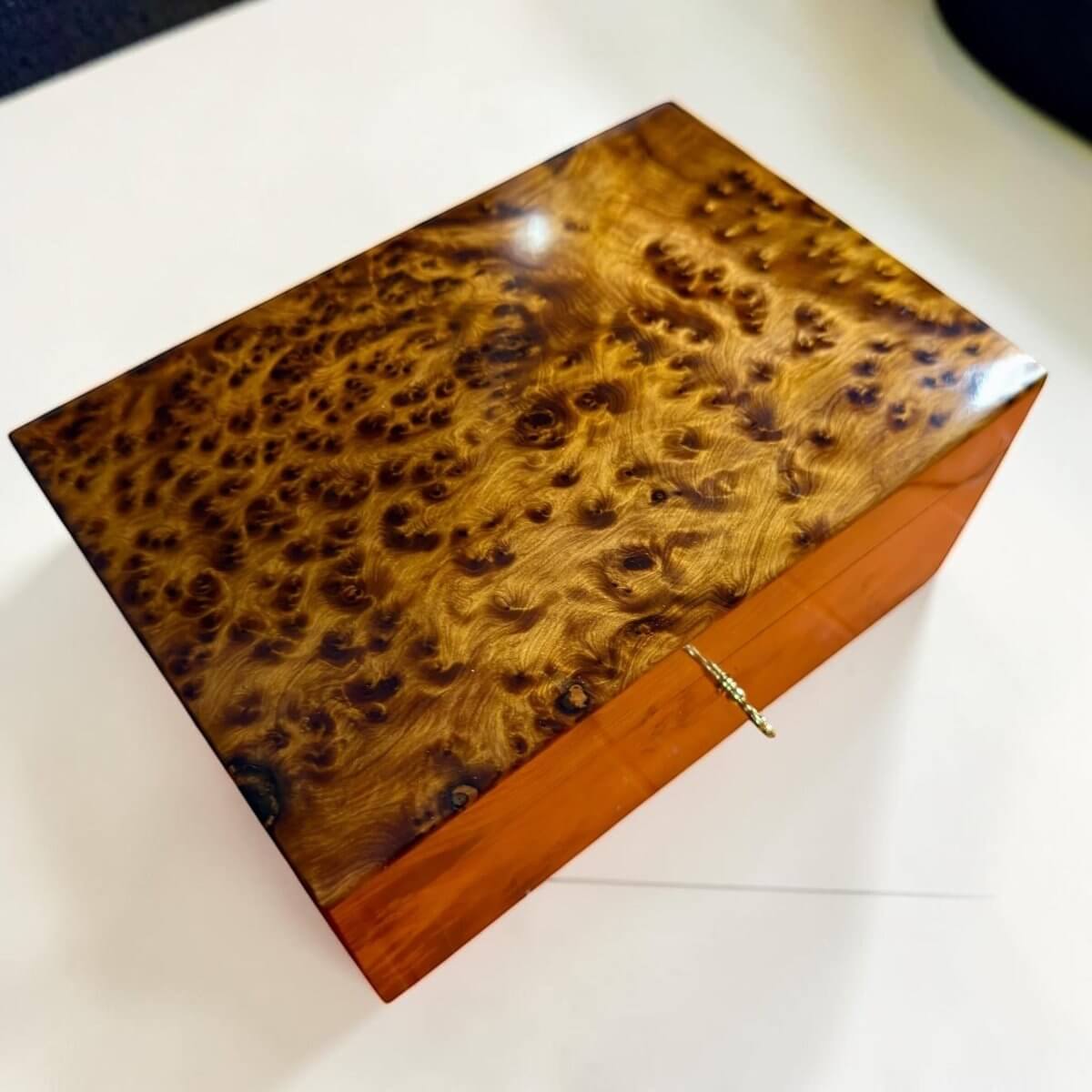 Handmade Thuya wood box with brass lock and warm burl grain