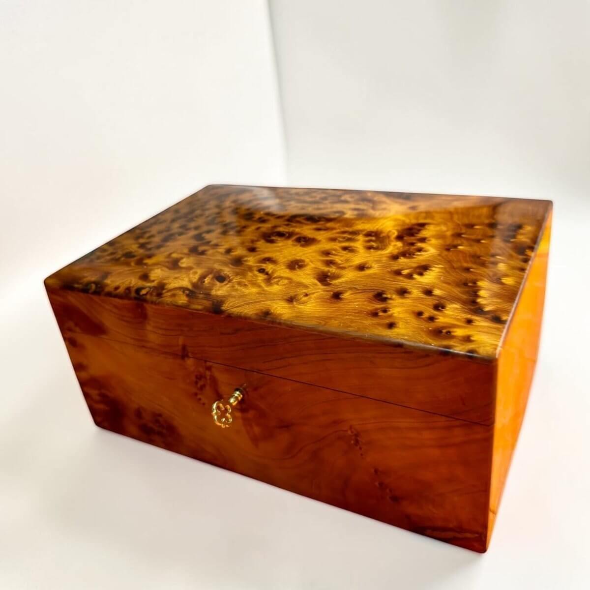 Handmade Thuya wood organizer box with brass lock and key detail