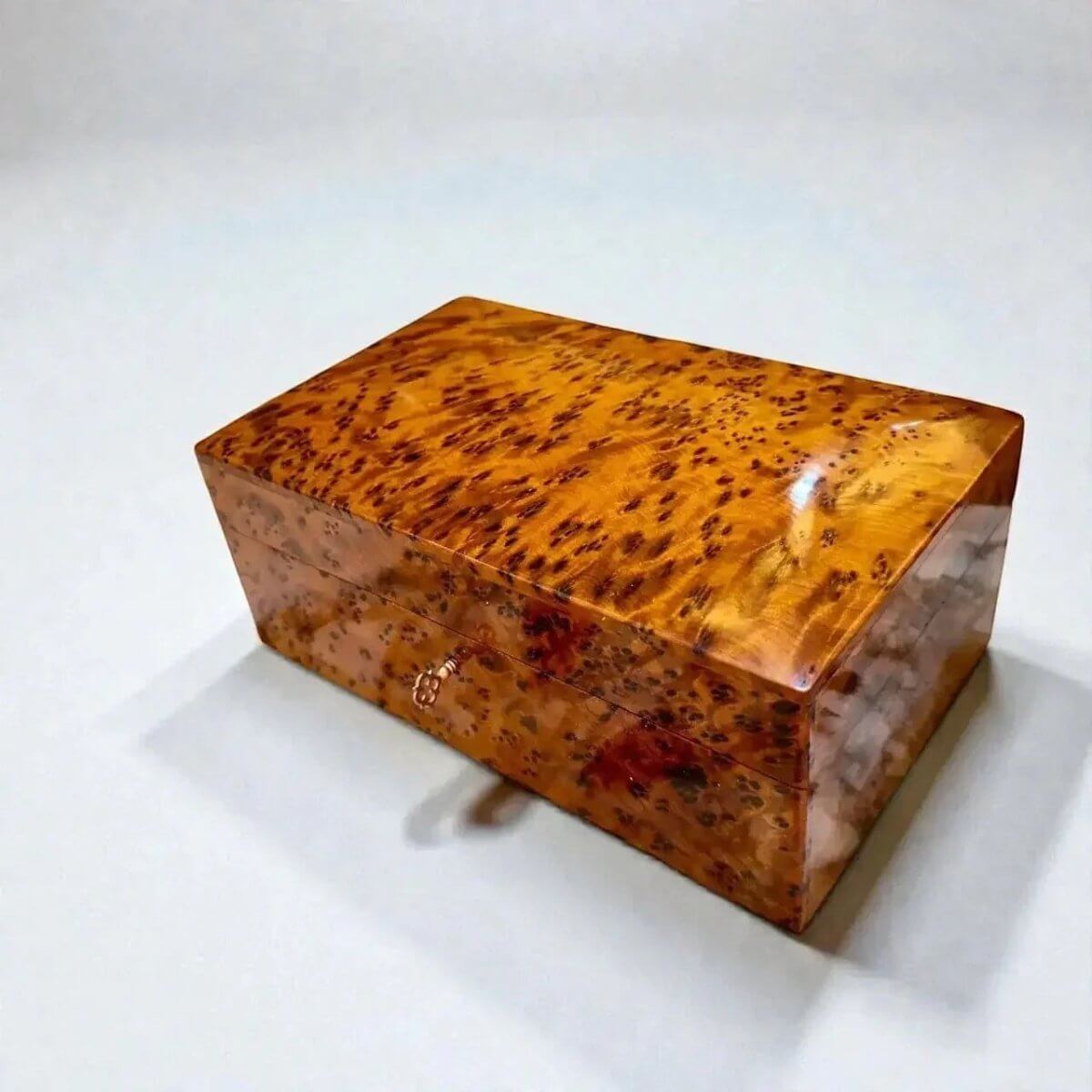 Thuya wood box featuring rich hues, handcrafted in Morocco, perfect as a handmade jewelry box with a key.