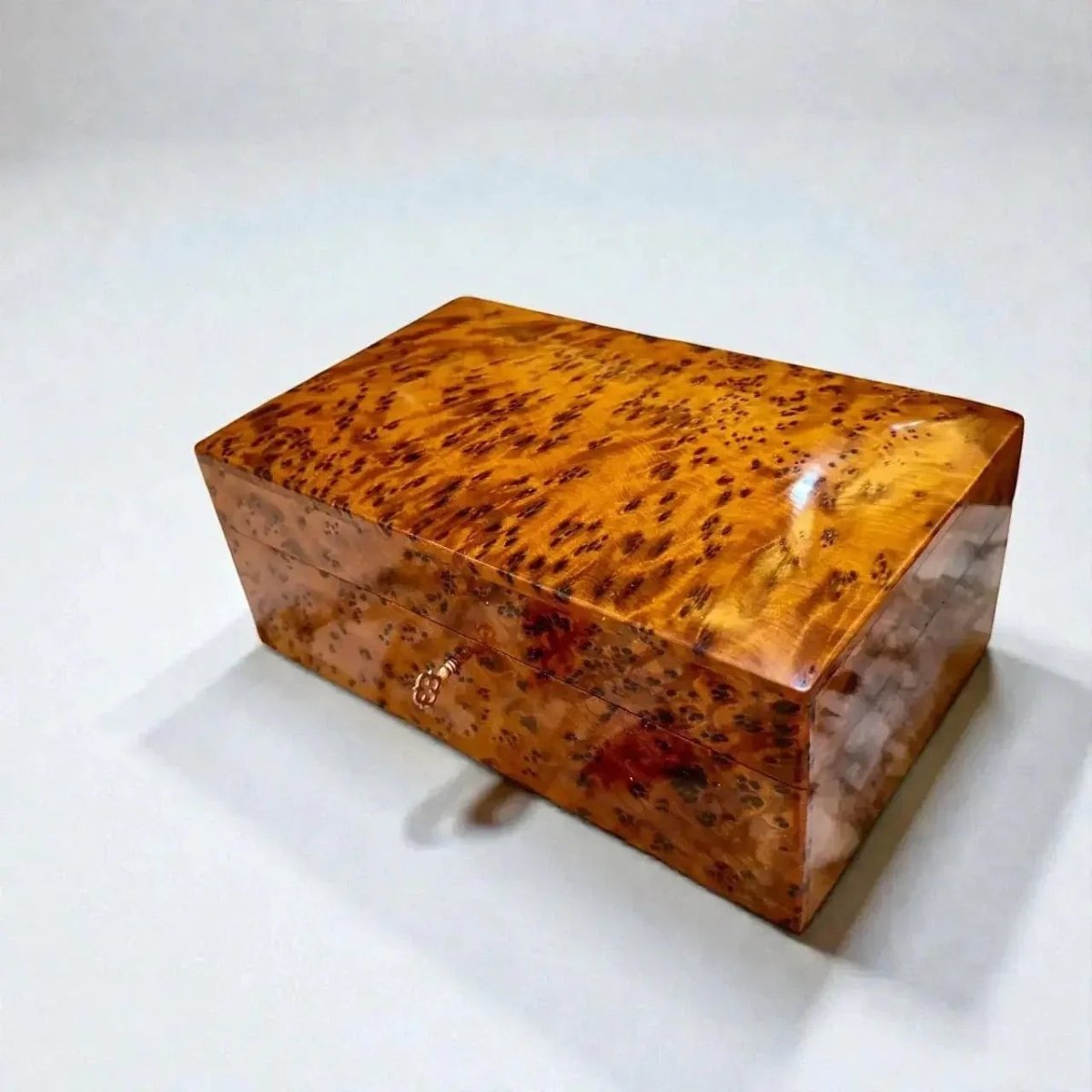 Small lockable wooden box with warm Thuya burl wood pattern