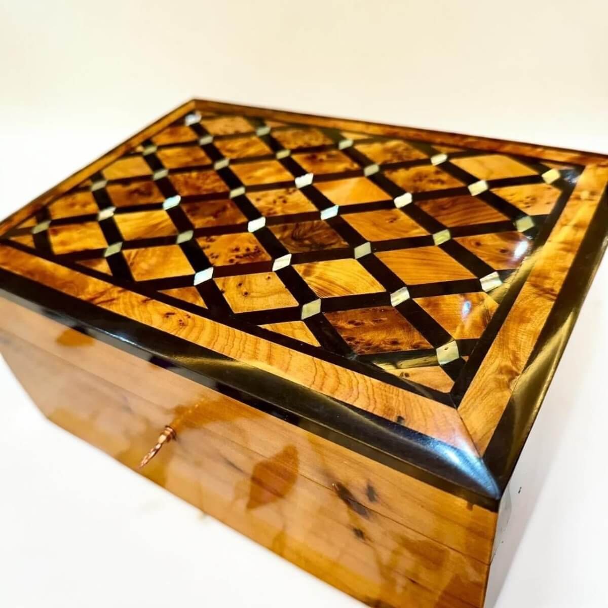 Handmade wooden jewelry box with polished Thuya grain and brass key detail