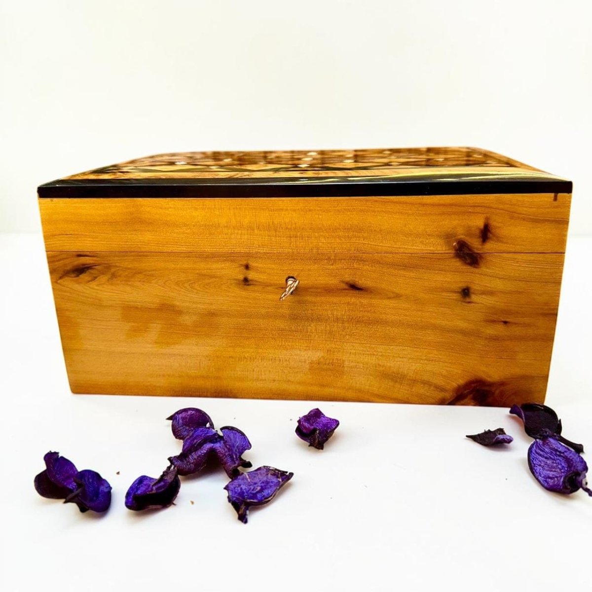 Handmade Thuya wood jewelry box with key detail and polished natural grain