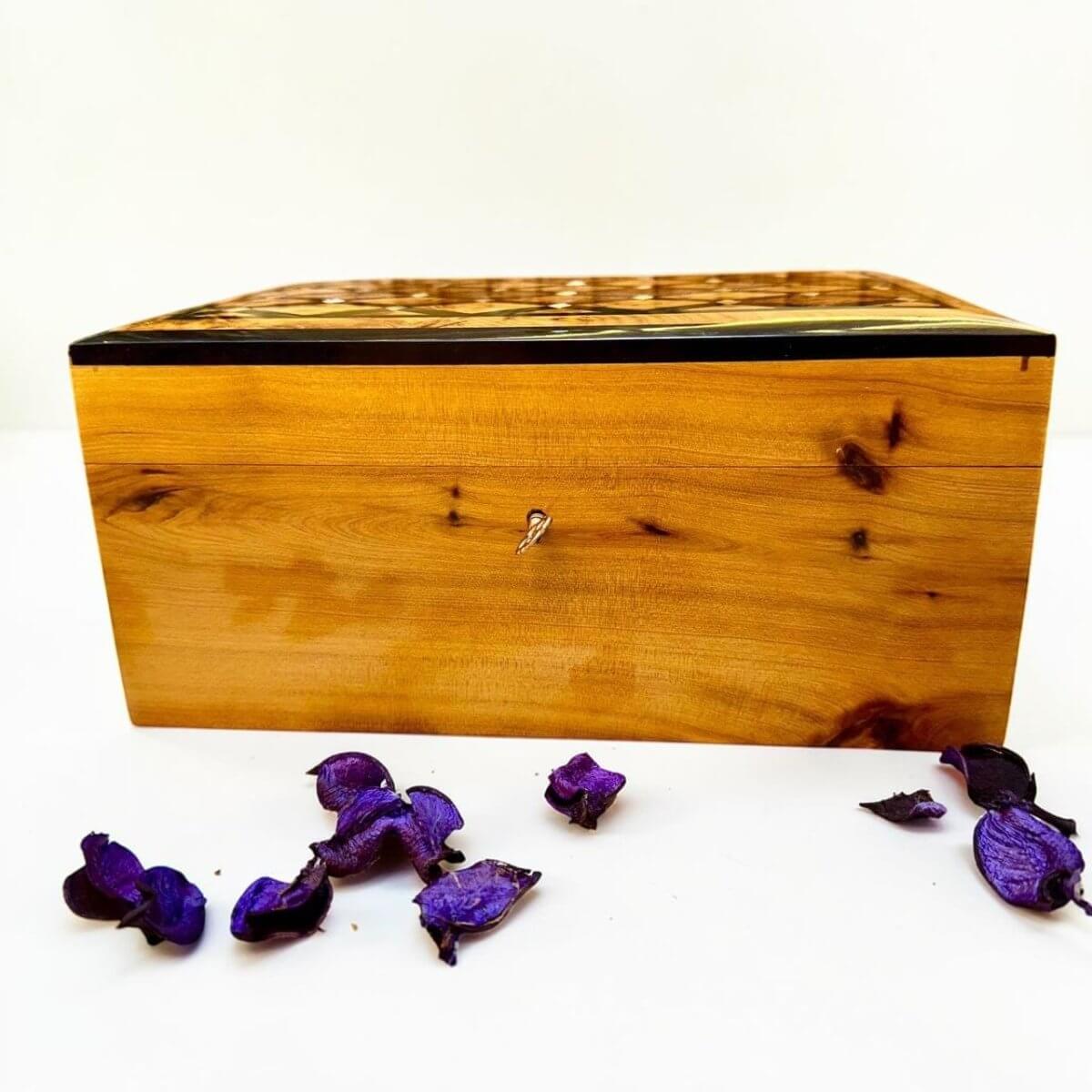 Handmade Thuya wood jewelry box with key detail and polished natural grain