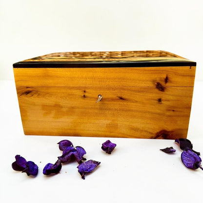 Handmade Thuya wood jewelry box with key detail and polished natural grain