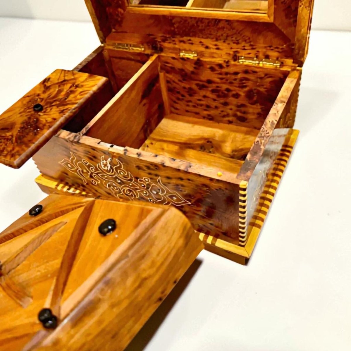 Open wooden jewelry box with mirror and divided interior compartments