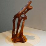 Hand-carved wooden sculpture with natural wood grain detail
