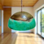 Copper Dome Pendant Light showcasing a unique green and bronze design in a modern interior setting.