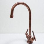 Bronze kitchen faucet on a white background