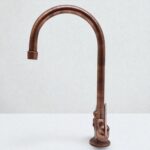Bronze kitchen faucet on a white background