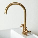 Gold kitchen faucet on a white background