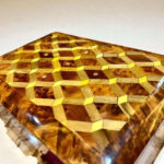AtlasMuseCrafts luxury wooden jewelry box organizer with geometric inlay pattern and brass key detail.