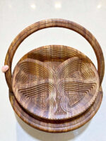 Folding walnut wood fruit basket with carved details and curved handle