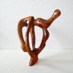 Handmade contemporary wood sculpture with flowing abstract form