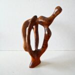 Contemporary wood sculpture with organic curves and natural finish